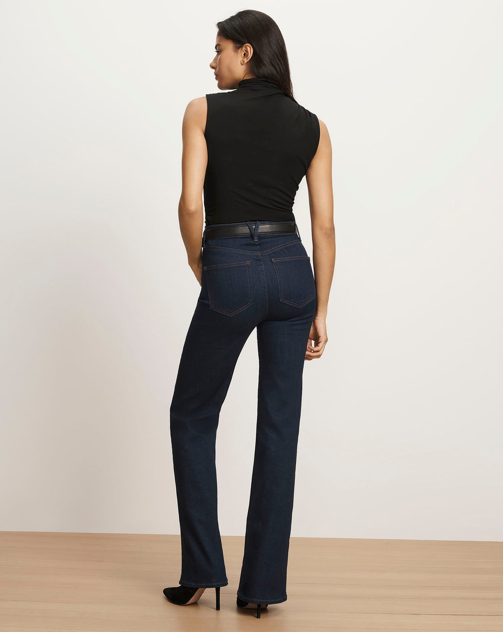 Veronica Beard Dark wash bootcut jeans, black sleeveless turtleneck.