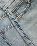 Veronica Beard Peach textured knit cardigan with short sleeves and light wash denim shorts.