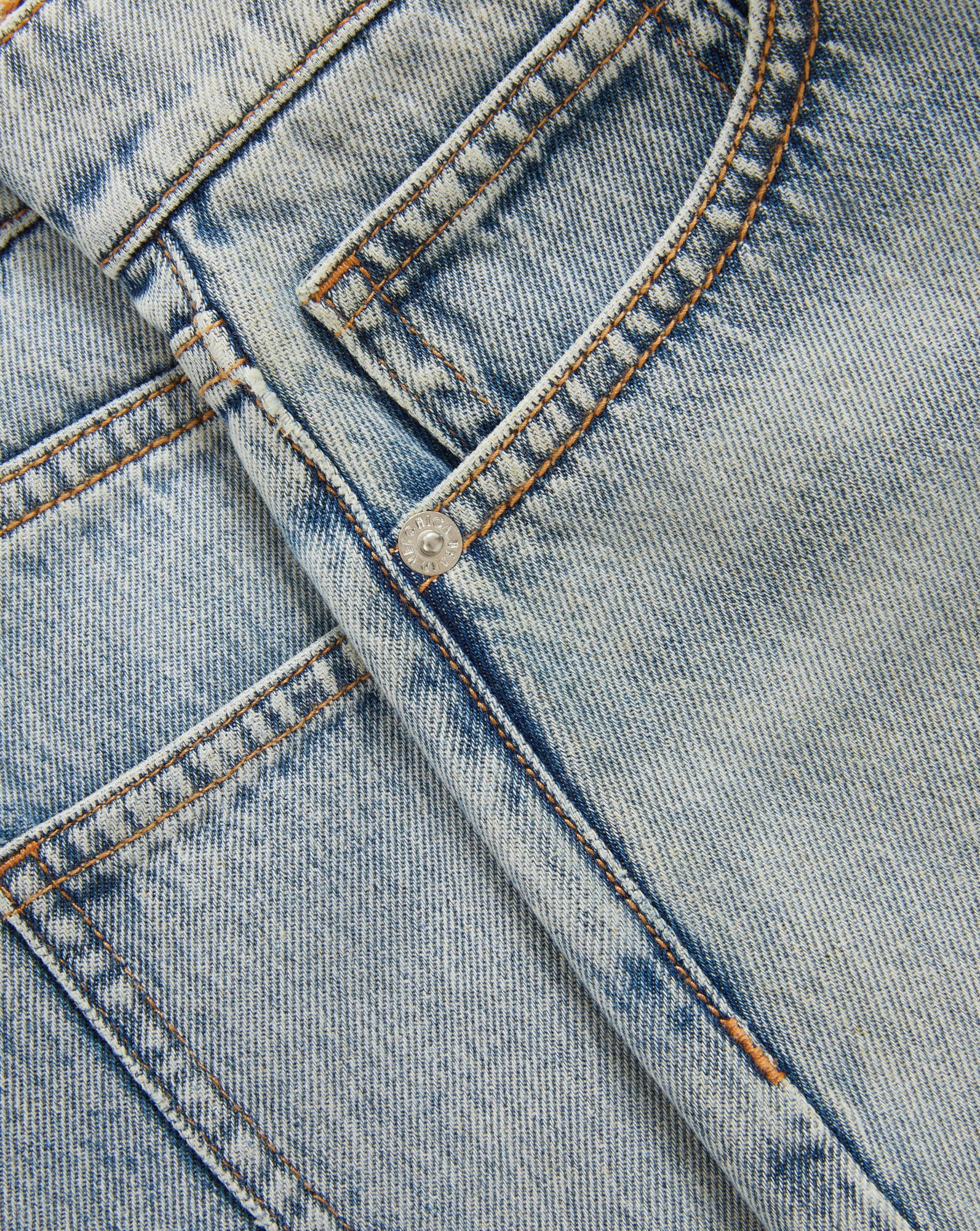 Veronica Beard Peach textured knit cardigan with short sleeves and light wash denim shorts.