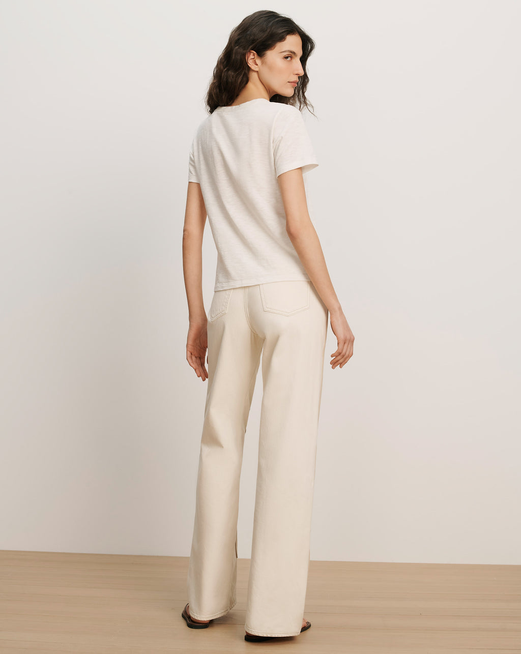 Veronica Beard Cream short-sleeve t-shirt and cream wide-leg pants.
