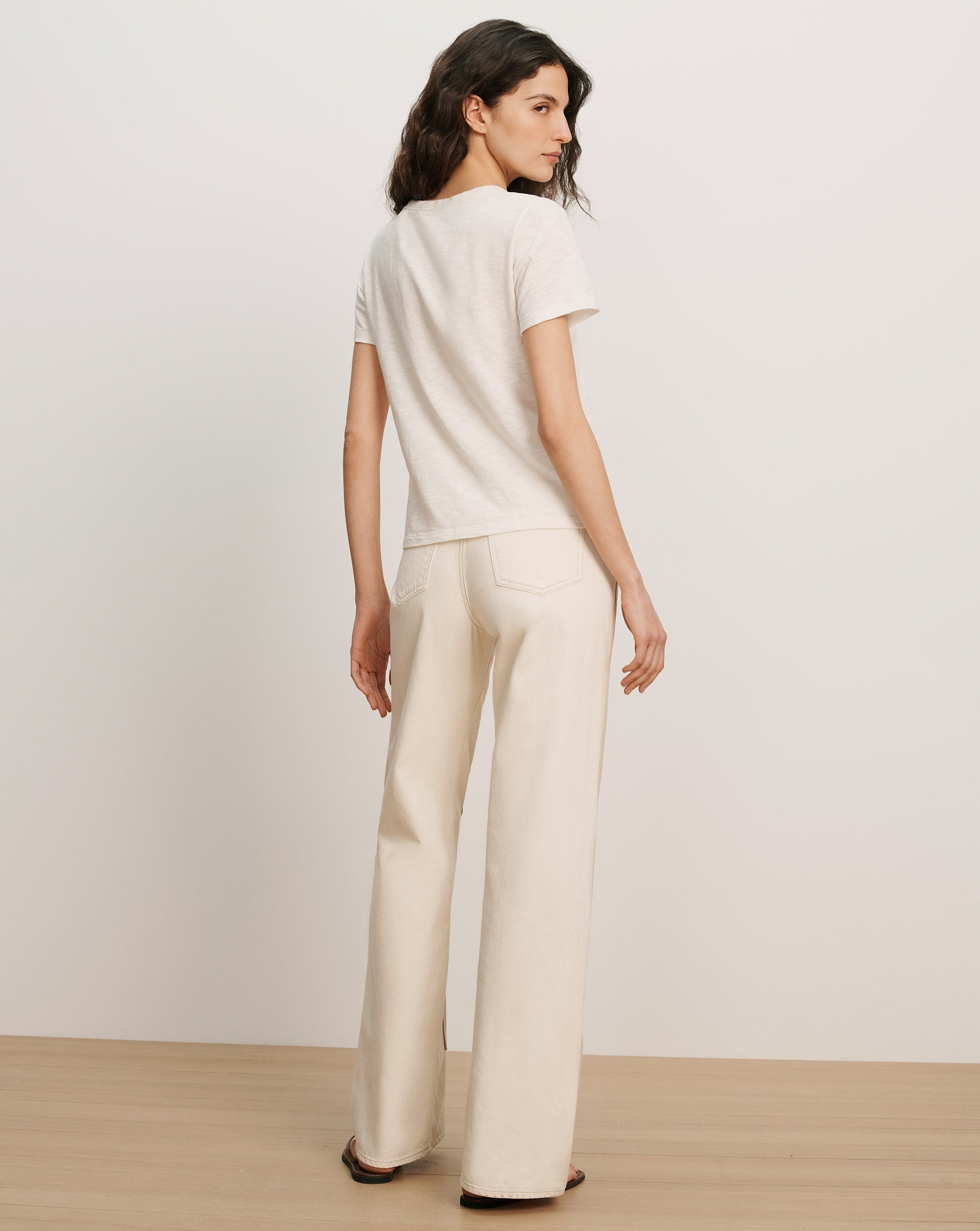 Veronica Beard Cream short-sleeve t-shirt and cream wide-leg pants.