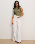 Veronica Beard Sleeveless green and brown patterned knit top with white wide-leg jeans.
