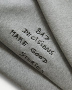 Veronica Beard Gray crewneck sweatshirt and black wide-leg jeans with white stitching.