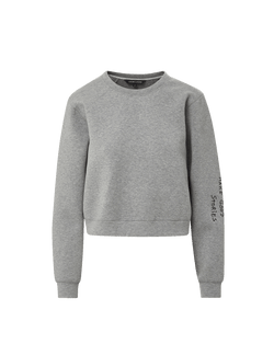 Veronica Beard Gray crewneck sweatshirt and black wide-leg jeans with white stitching.