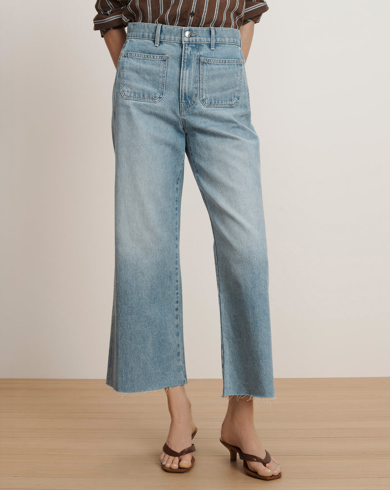 Veronica Beard Light wash wide-leg jeans with front patch pockets and a raw hem.