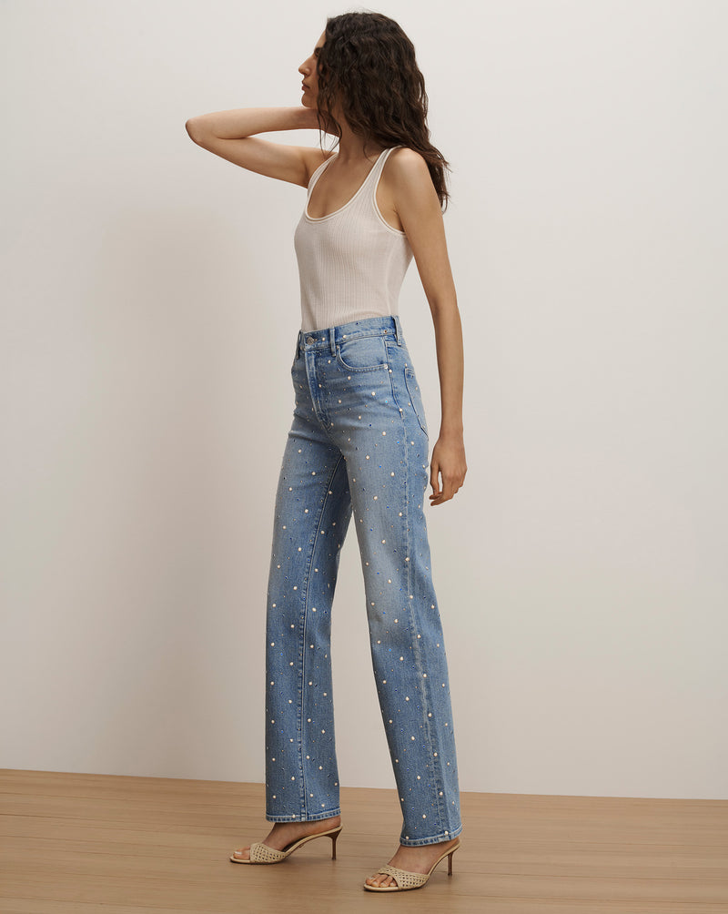 Veronica Beard Light wash denim jeans with scattered pearl embellishments, paired with a white ribbed tank top.