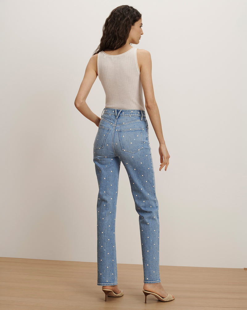 Veronica Beard Light wash denim jeans with an all-over pearl embellishment, paired with a ribbed cream tank top.