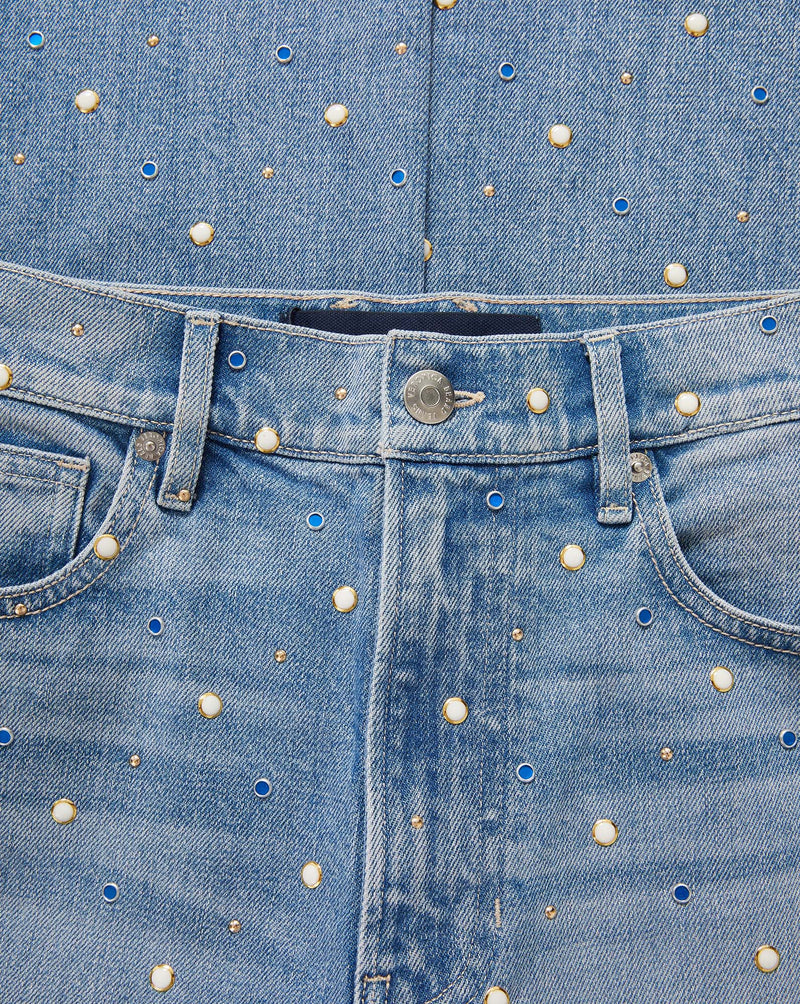 Veronica Beard Light wash denim jeans with scattered blue, gold, and pearl-like embellishments.