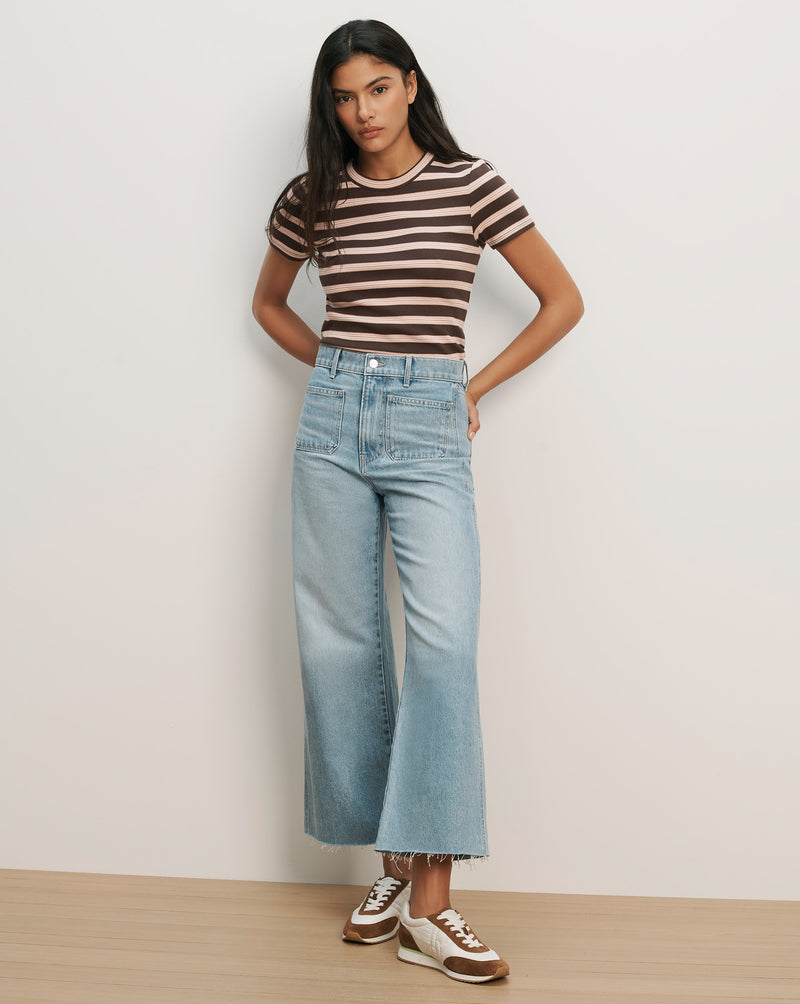 Veronica Beard Brown and pink striped knit t-shirt with light wash wide-leg jeans.