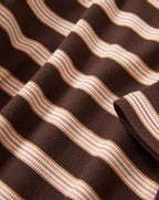 Veronica Beard Brown and pink striped knit t-shirt with light wash wide-leg jeans.