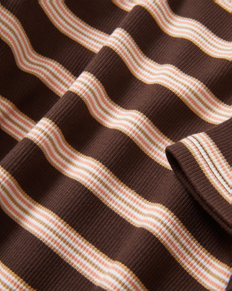 Veronica Beard Brown and pink striped knit t-shirt with light wash wide-leg jeans.