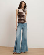 Veronica Beard Brown and white striped sleeveless knit top with a button-front placket, paired with light wash flared jeans.