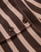 Veronica Beard Brown and pink striped sleeveless knit top with light wash flared jeans.