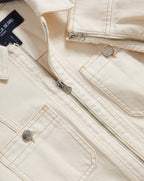 Veronica Beard Cream denim jacket with silver zippers and buttons.