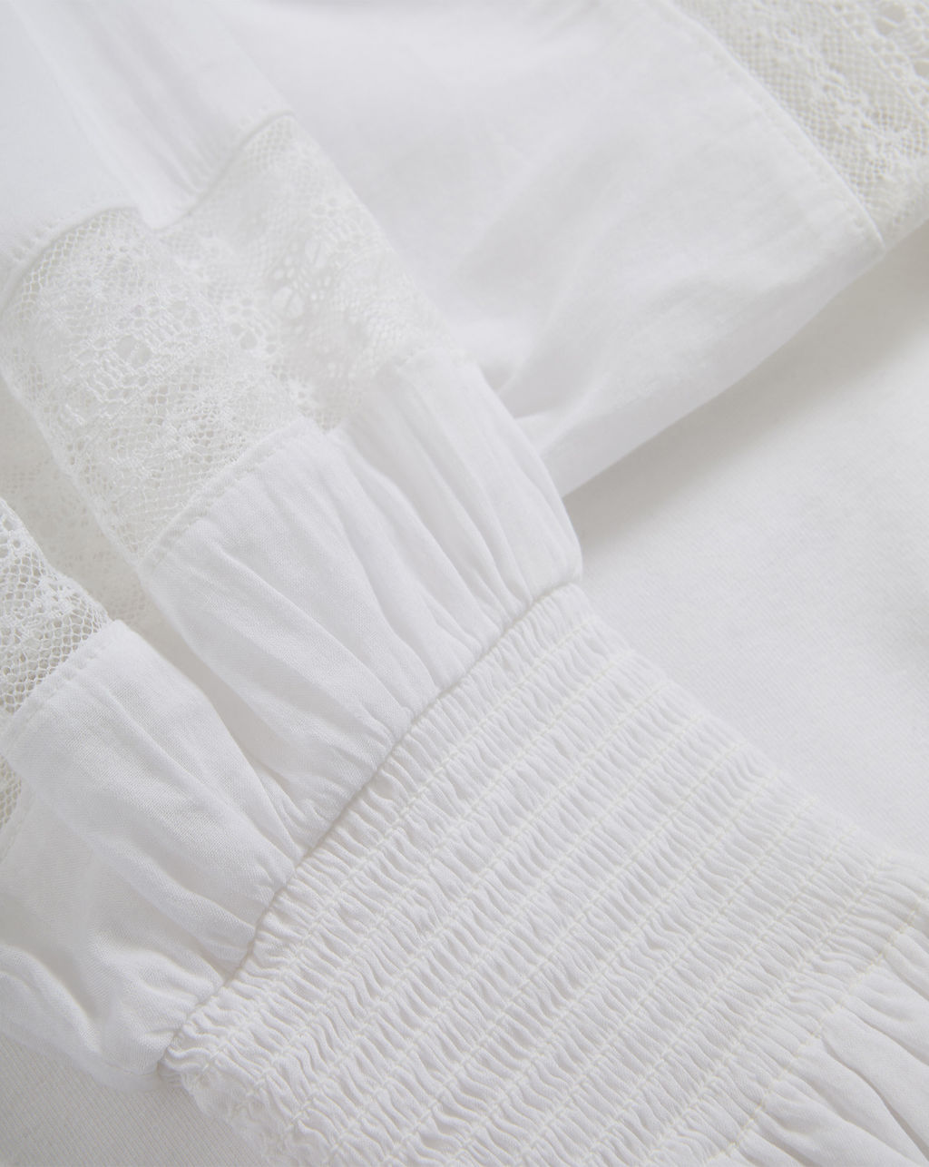 Veronica Beard White cotton blouse with lace and smocked details.