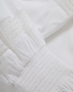 Veronica Beard White cotton blouse with lace and smocked details.