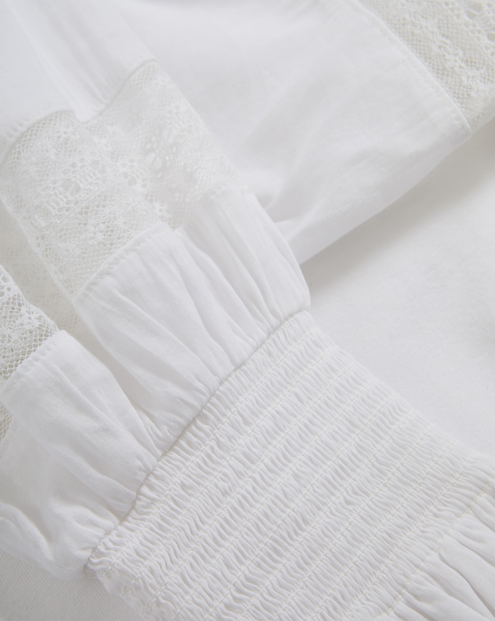 Veronica Beard White cotton blouse with lace and smocked details.
