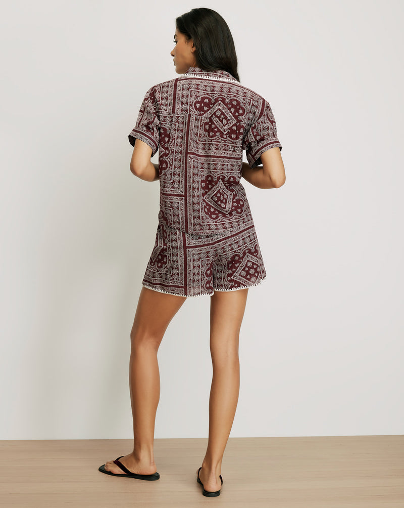 Veronica Beard Maroon patterned short-sleeve top with white trim.