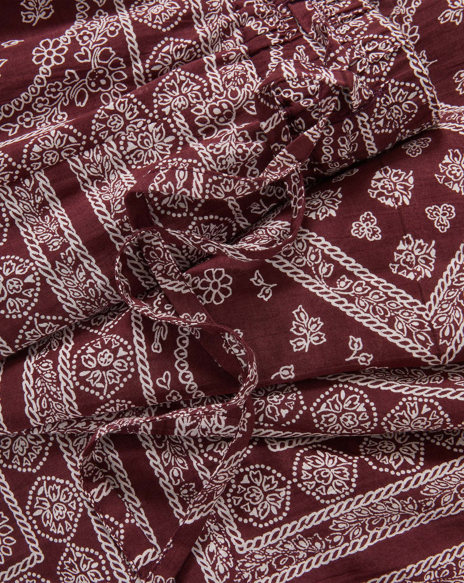 Veronica Beard Maroon and white patterned bandana print dress with ruffles.