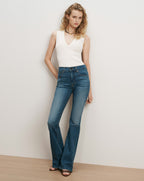 Veronica Beard Blue denim flare jeans with a tan belt.