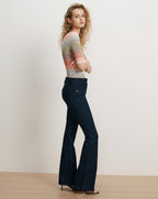 Veronica Beard Dark wash denim flare jeans and a striped knit top.