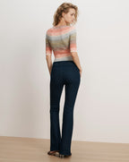 Veronica Beard Dark wash flare jeans and striped knit top.