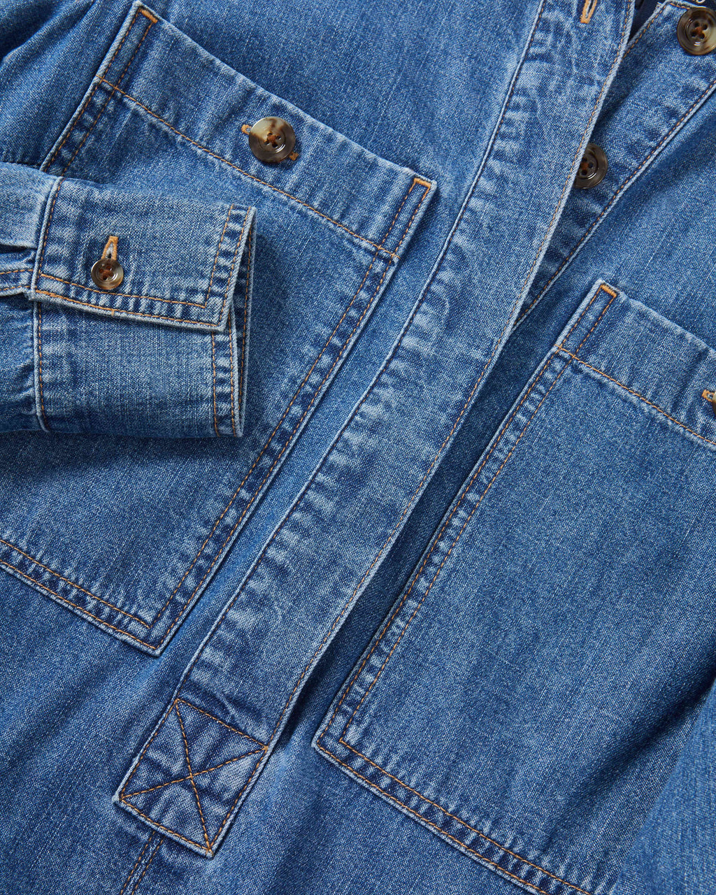 Veronica Beard Blue denim jacket with brown buttons and pockets.