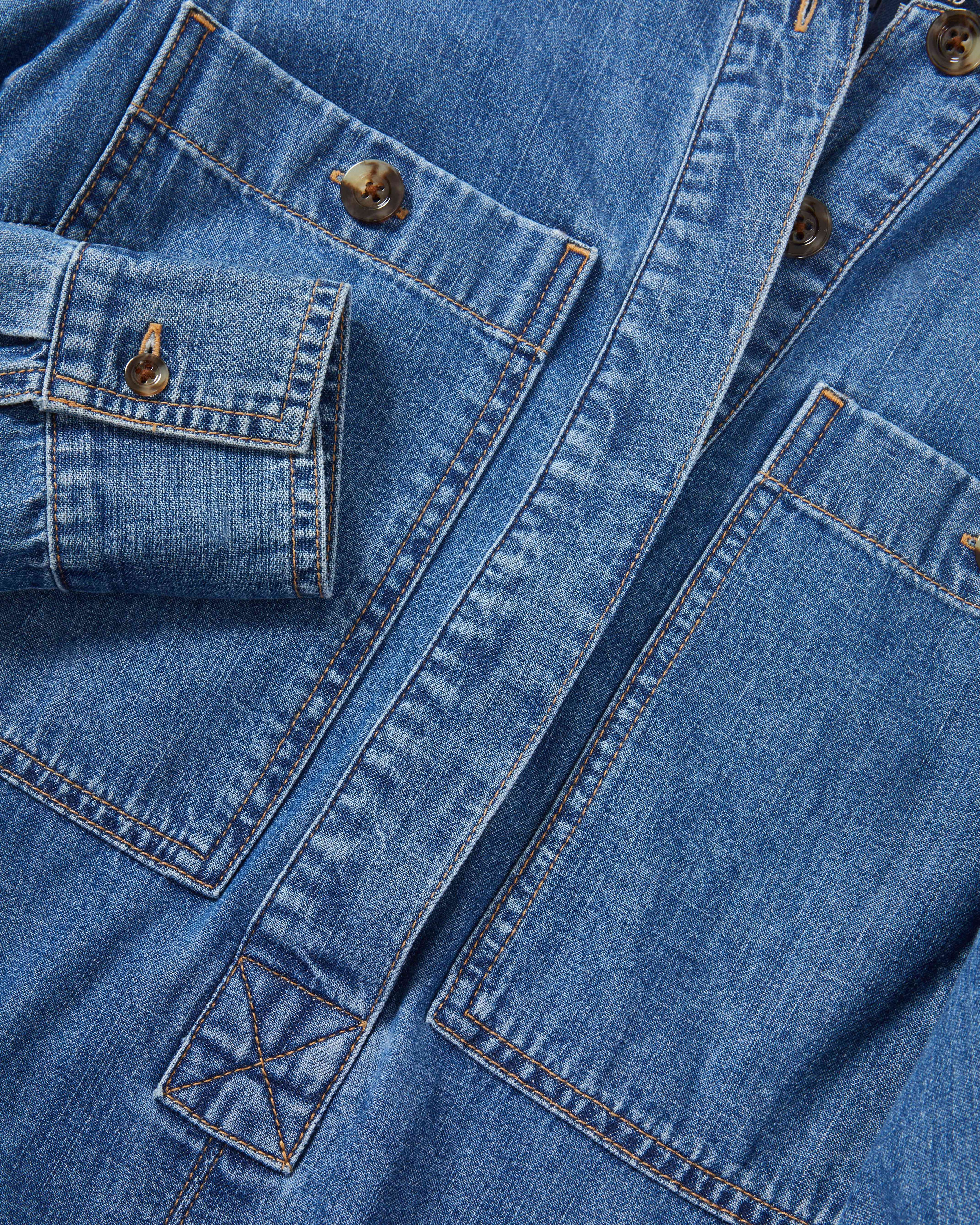Veronica Beard Blue denim jacket with brown buttons and pockets.