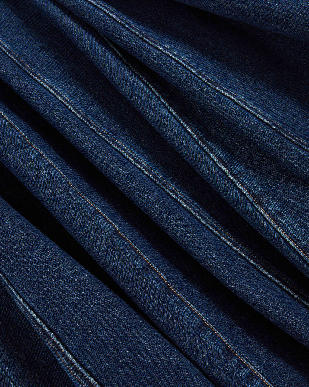 Veronica Beard Blue denim fabric with diagonal pleats and stitching.