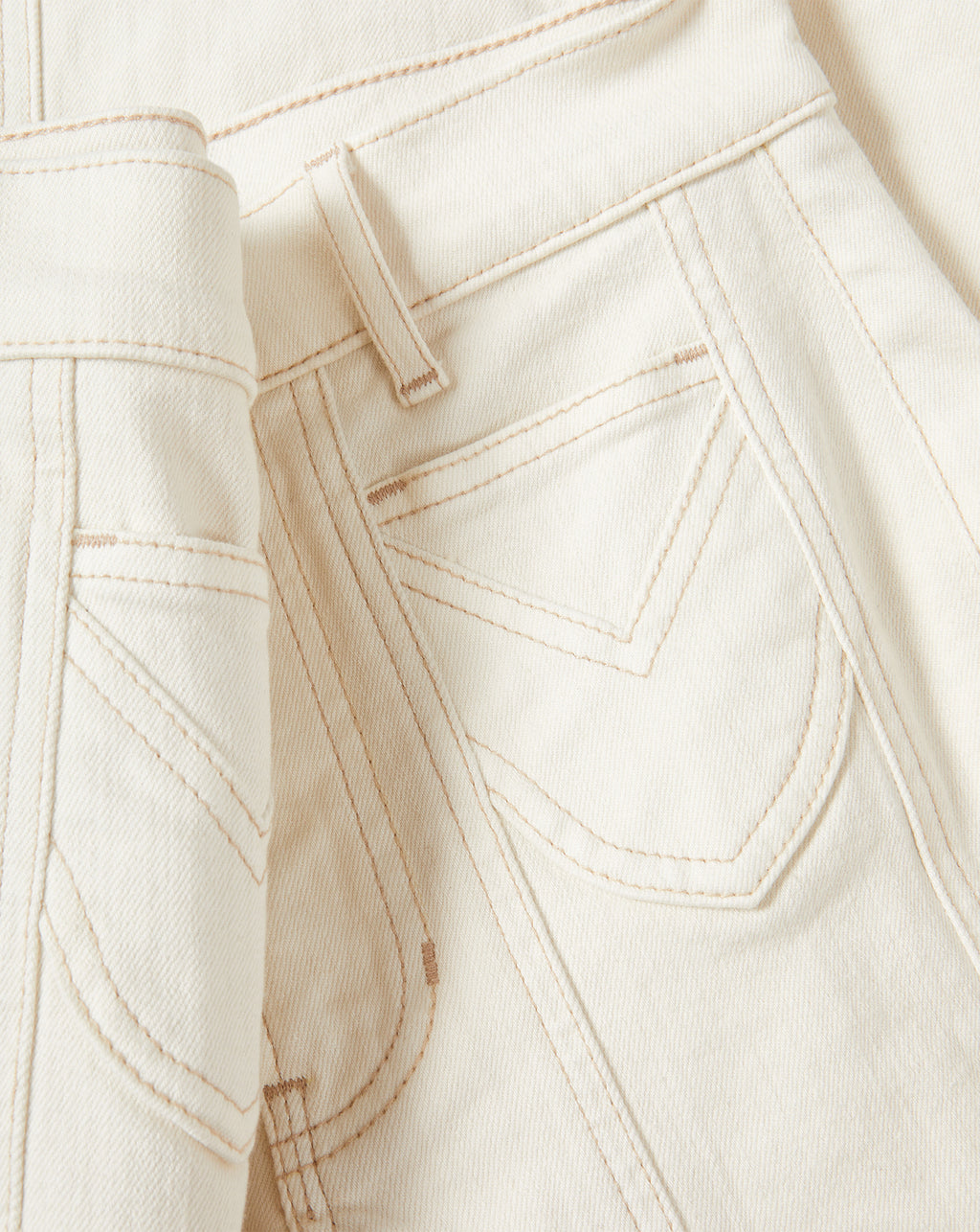 Veronica Beard Cream denim jeans with tan stitching and back pockets.