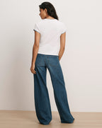Veronica Beard White cotton t-shirt with blue trim, wide-leg jeans.