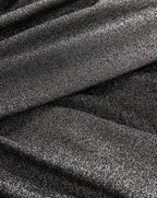 Veronica Beard Black metallic glitter fabric with draped texture.