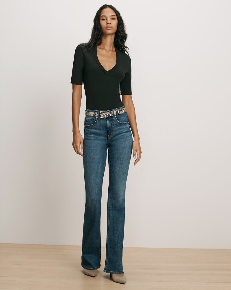 Veronica Beard Black short-sleeve V-neck top and blue jeans.