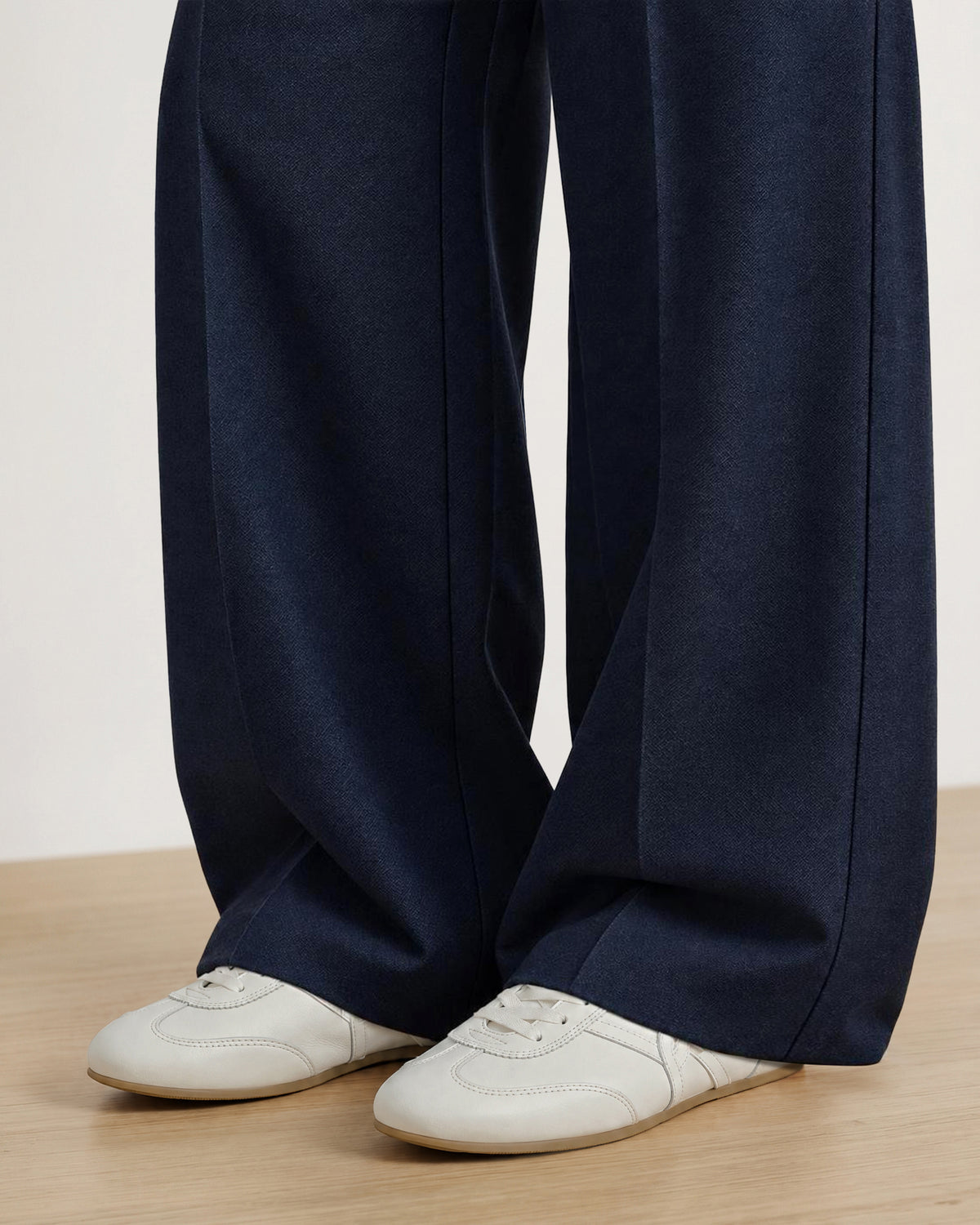 Veronica Beard Dark blue wide-leg textured trousers with creased seams.