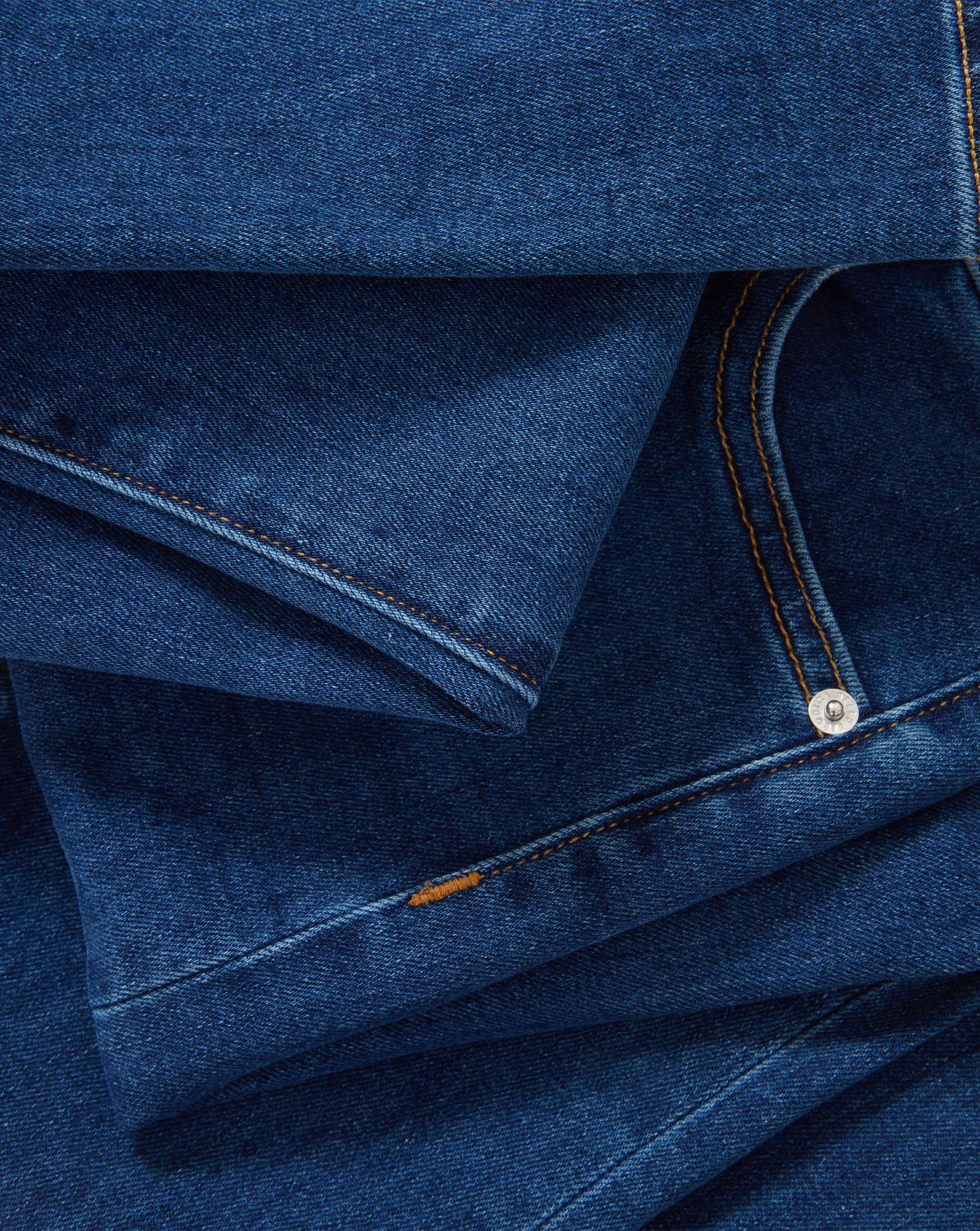 Veronica Beard Blue denim jeans with orange stitching and silver button.