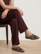 Veronica Beard Brown pants and zebra print mules.