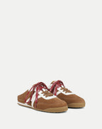Veronica Beard Brown suede mule sneakers with white stripes and red laces.