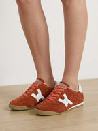 Veronica Beard Brown suede sneakers with white accents and orange laces.