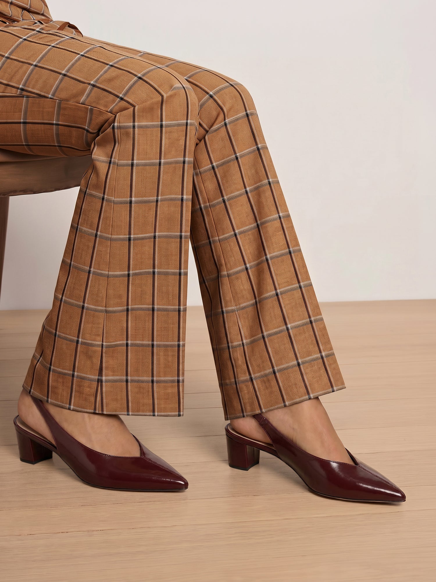 Veronica Beard Brown plaid trousers and burgundy slingback heels.
