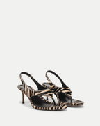 Veronica Beard Zebra print calf hair thong sandals with stiletto heels.