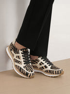 Veronica Beard Zebra print calf hair sneakers with black laces.