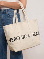 Veronica Beard Cream canvas tote bag with "VERONICA BEARD" in black.
