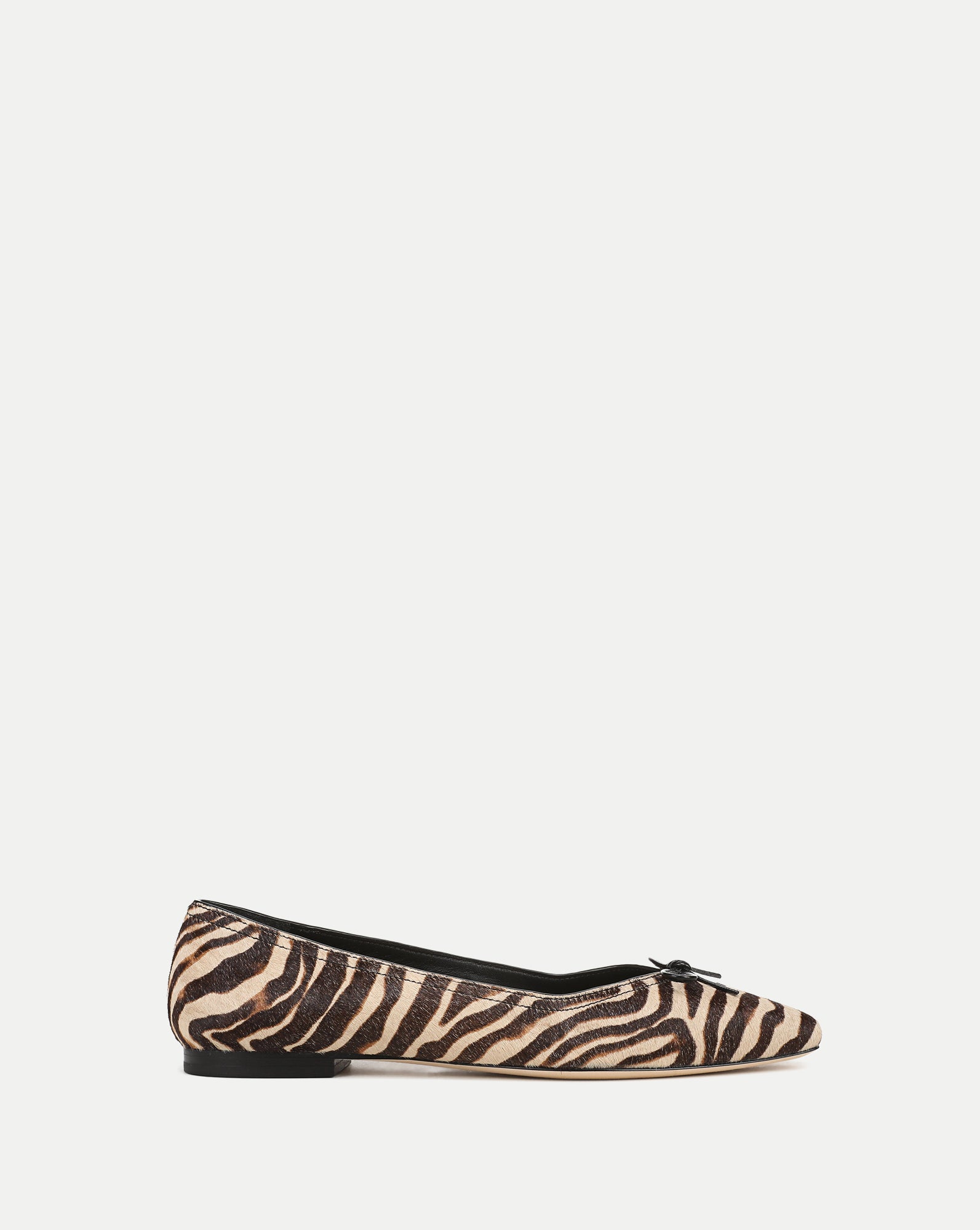 Veronica Beard Zebra print pointed-toe flats with small bow detail.