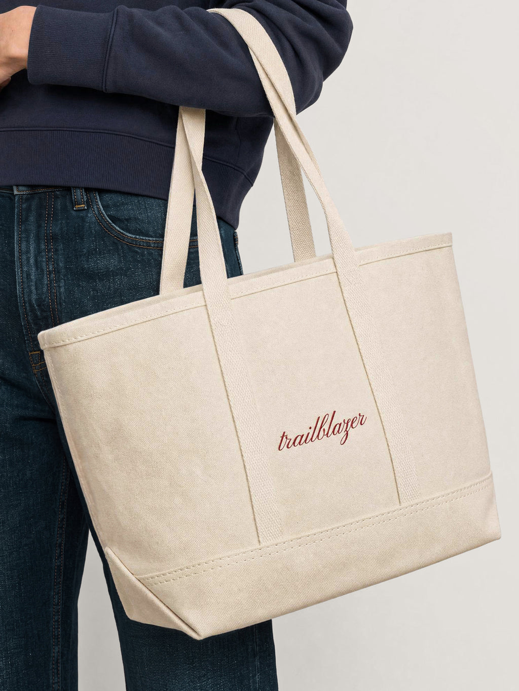 Veronica Beard Beige canvas tote bag with red embroidered text.