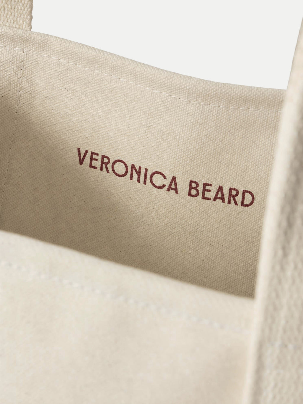 Veronica Beard Beige canvas tote bag with red logo text.