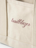 Veronica Beard Beige canvas tote bag with maroon trailblazer text.
