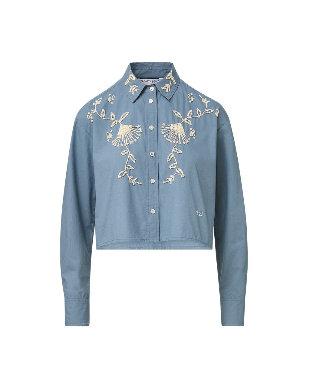 Veronica Beard Blue embroidered button-up shirt and cream wide-leg pants.