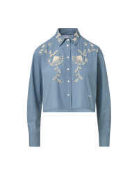 Veronica Beard Blue embroidered button-up shirt and cream wide-leg pants.