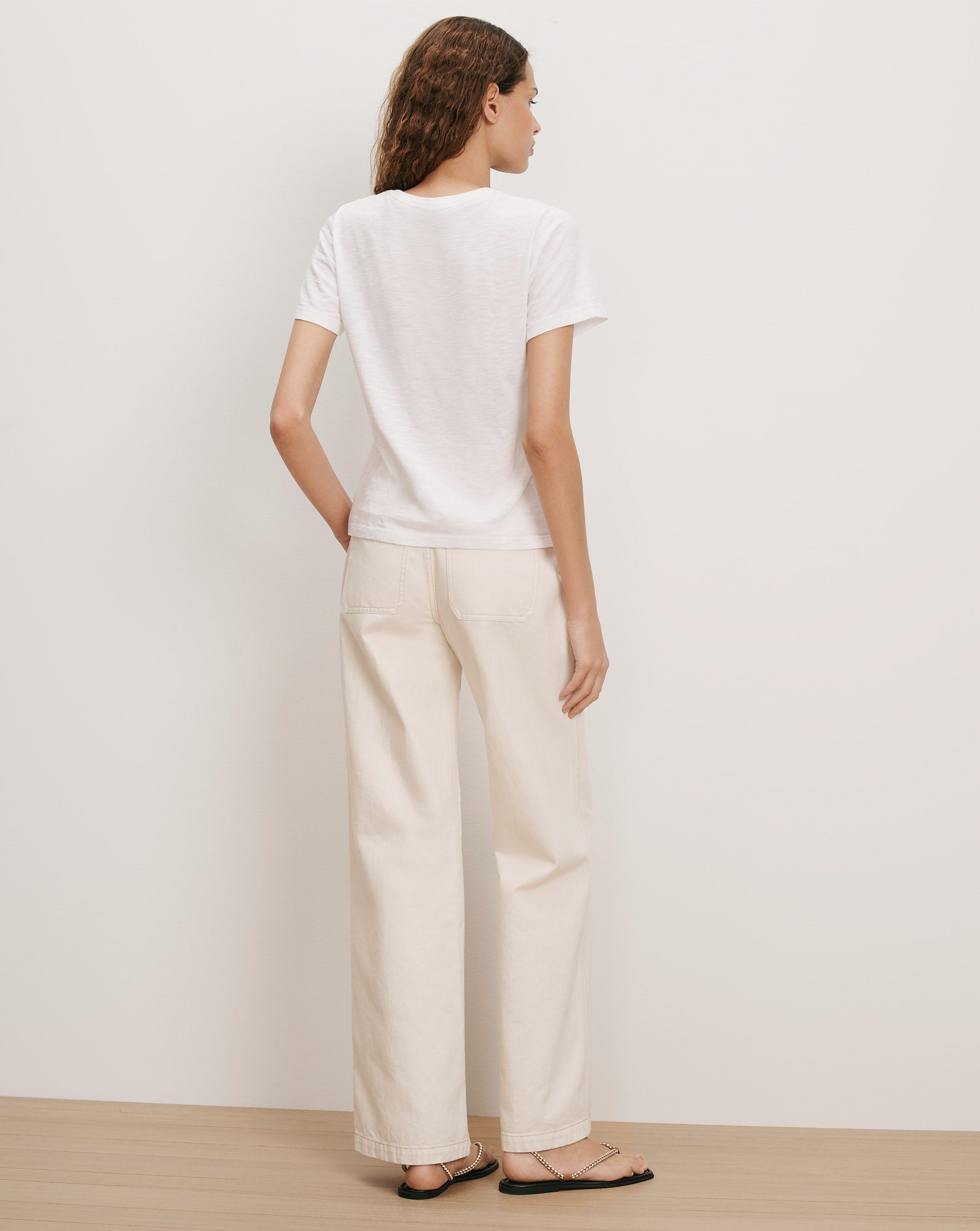 Veronica Beard White cotton t-shirt and cream wide-leg jeans.