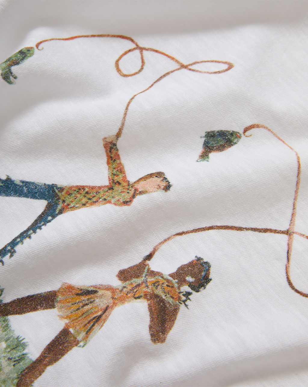 Veronica Beard White graphic t-shirt and blue geometric patchwork jeans.